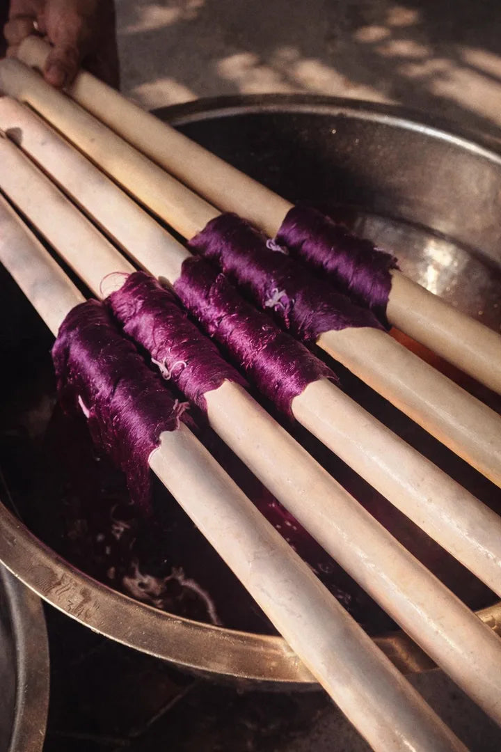 Yarns submerged in dye bath